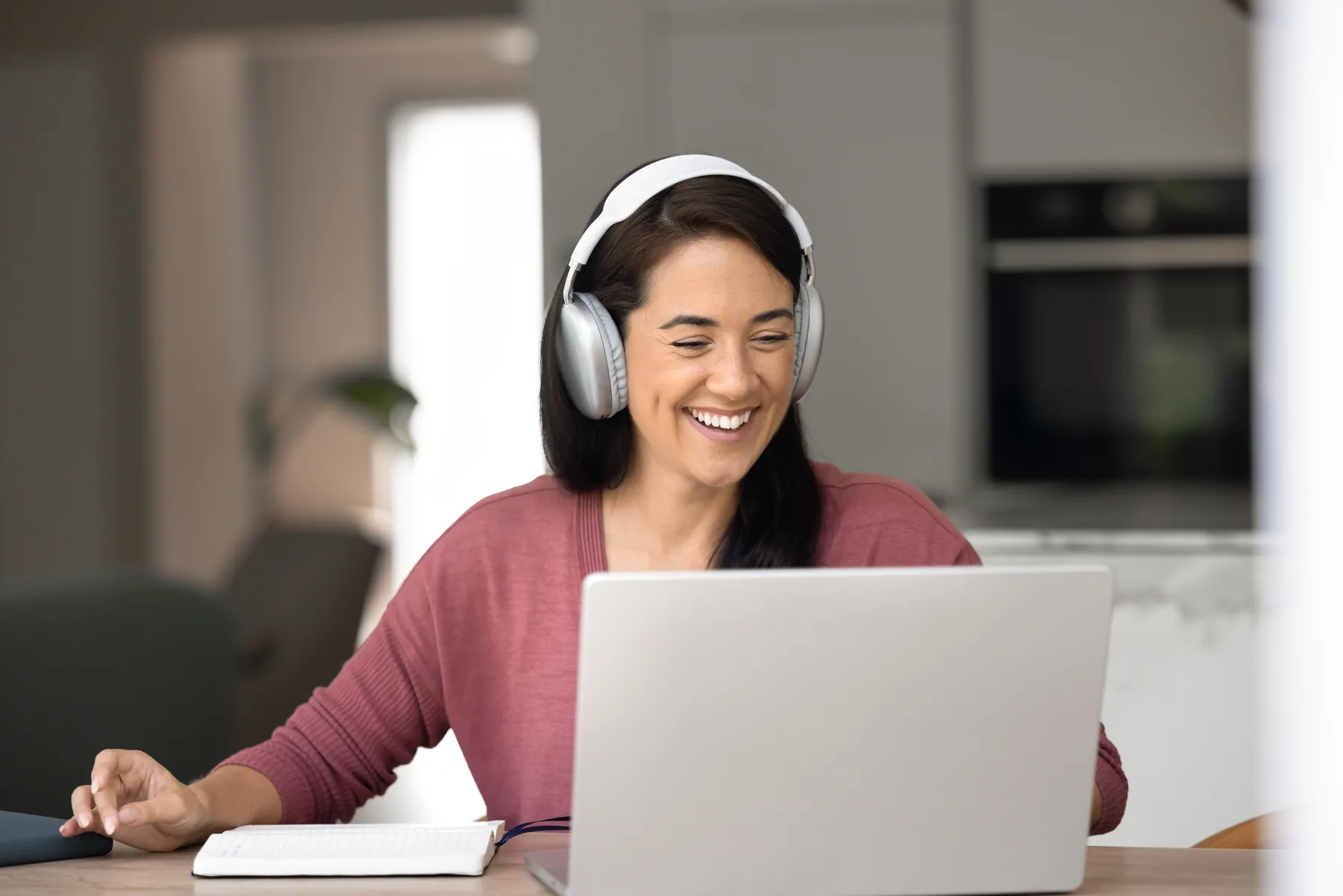 Online learner using headphones and a laptop at home
